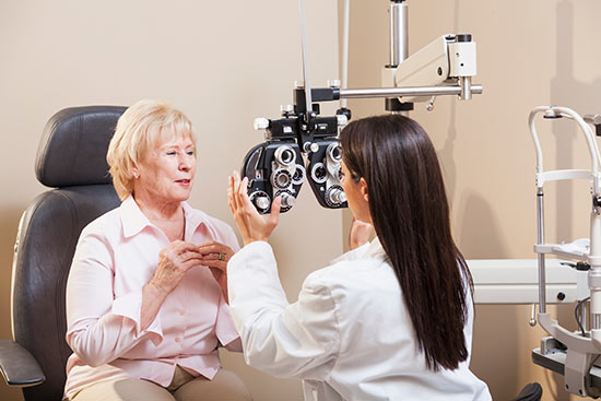 Middle aged woman getting her eyes checked at the eye doctor